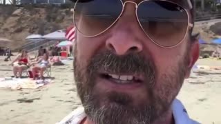 Left wing extremist gets angry upon seeing the American flag on the beach
