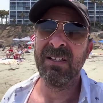Left wing extremist gets angry upon seeing the American flag on the beach