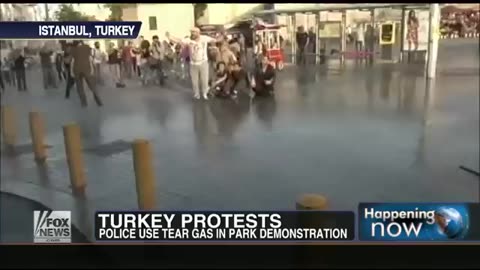 Protestor in Turkey gets air when hit with a water cannon