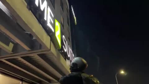 Anti-ICE protesters destroying sign of Home2 Suites Hotel in Minneapolis, were they believe ICE is