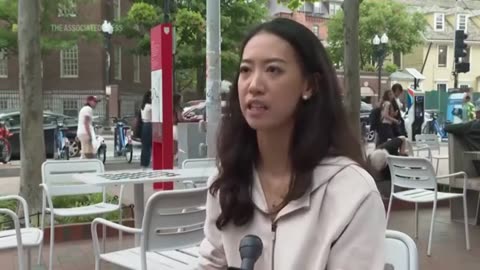 Harvard Graduate Gives Interview About Division as Fist Fight Breaks Out Behind Her