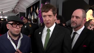 Guests and nominees wear 'ICE OUT' pins at this year's Grammys