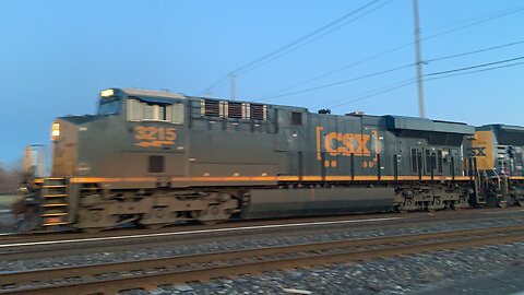 CSX Trains 3215 and SD 70AC 4739 pull mixed freight along the tracks