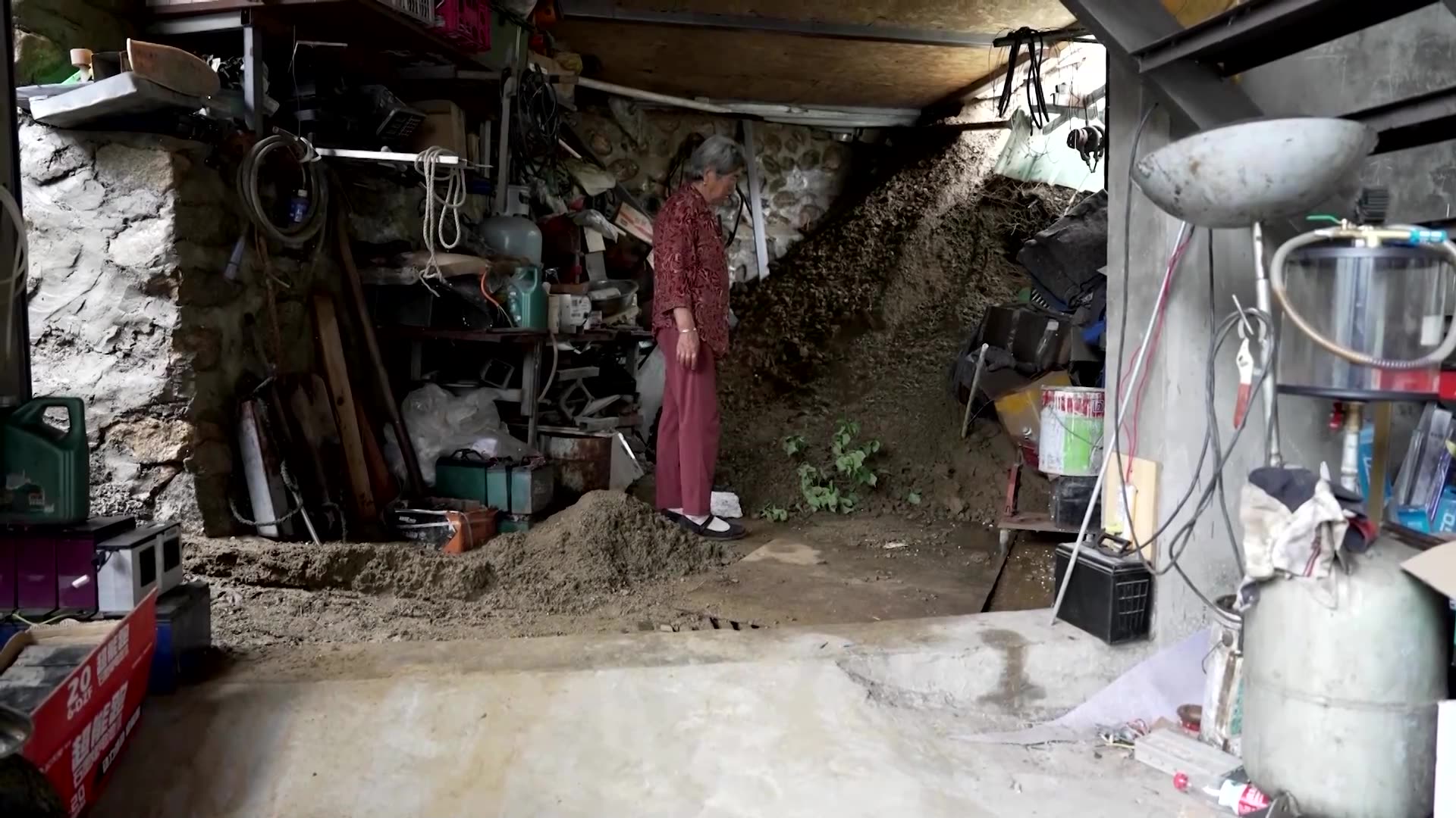 Beijing floods, landslide punch hole in home wall