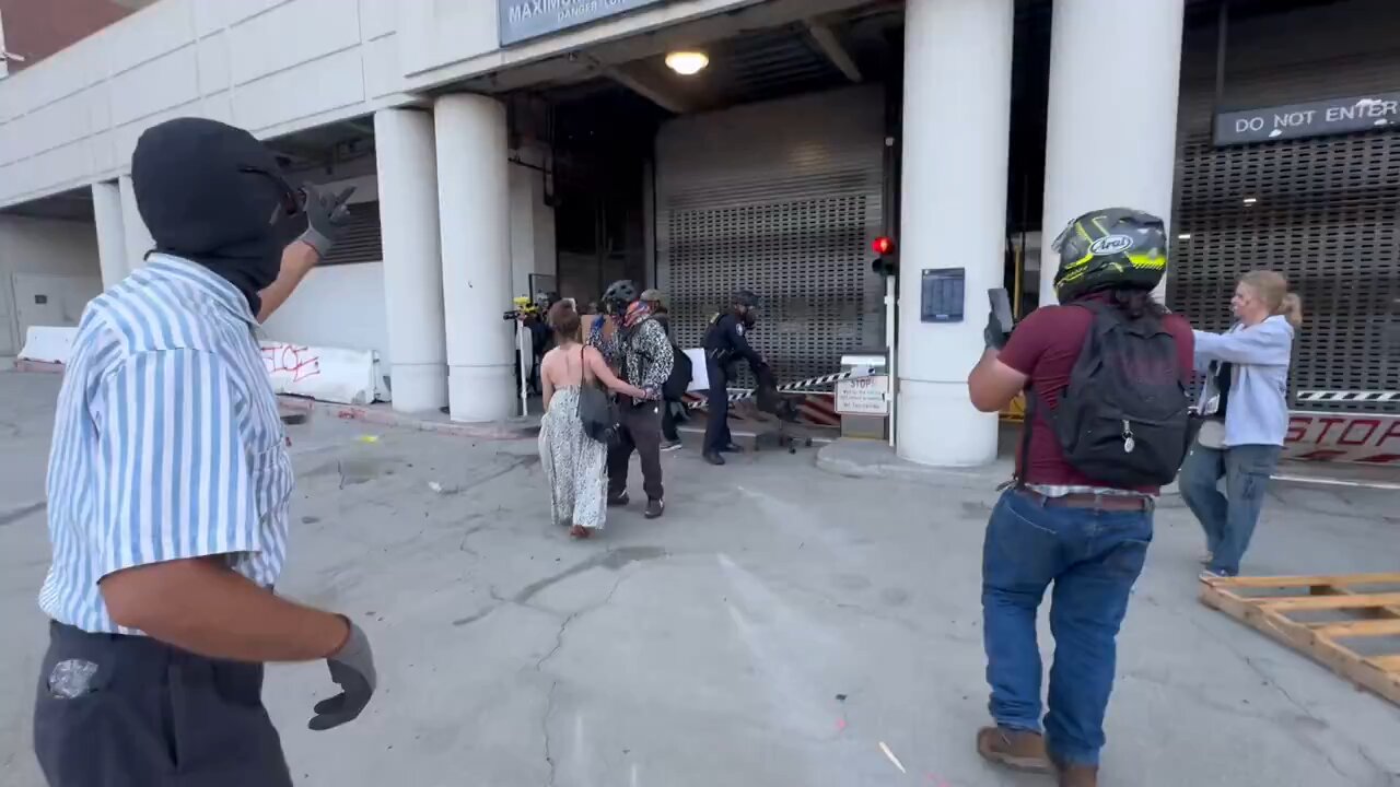 Rioters scatter as loud bangs and less than lethal used for crowd control.