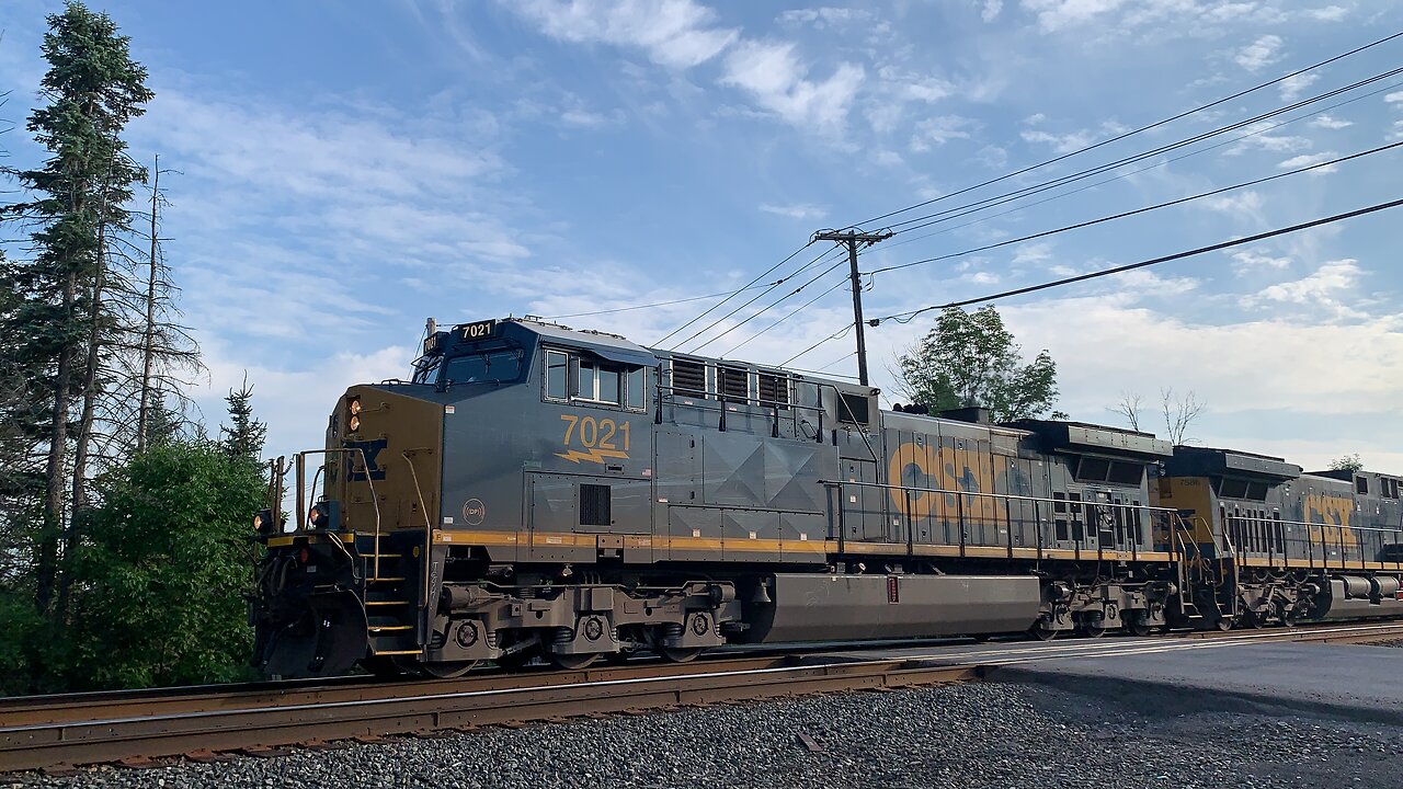 CSX Trains 7021 and 7586 head East