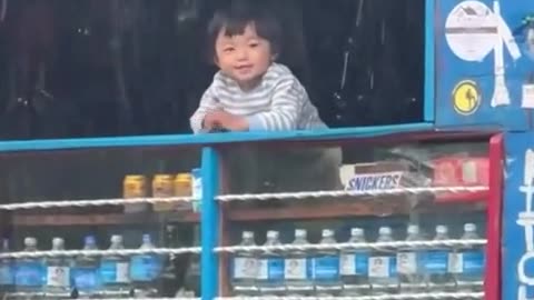 a small child gets happy at the sight of arrival of rain