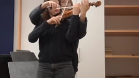 Two Musicians Perform on a Single Violin