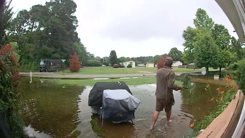 UPS Driver Delivers Heavy Package Through Flooded Yard