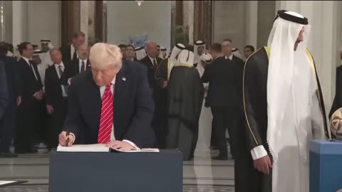The Emir presents President Trump with a ball from the 2022 FIFA World Cup in Qatar r