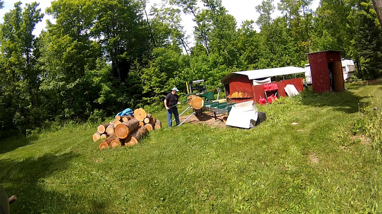 Sawmill: Cutting a large pine log to use in the rental remodel.