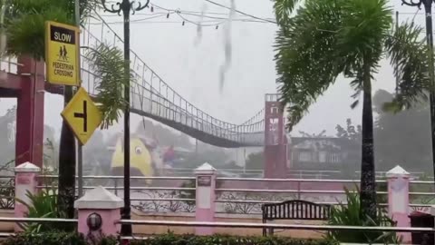 Powerful winds from Typhoon Fung-wong shake a suspension bridge in Camaligan,