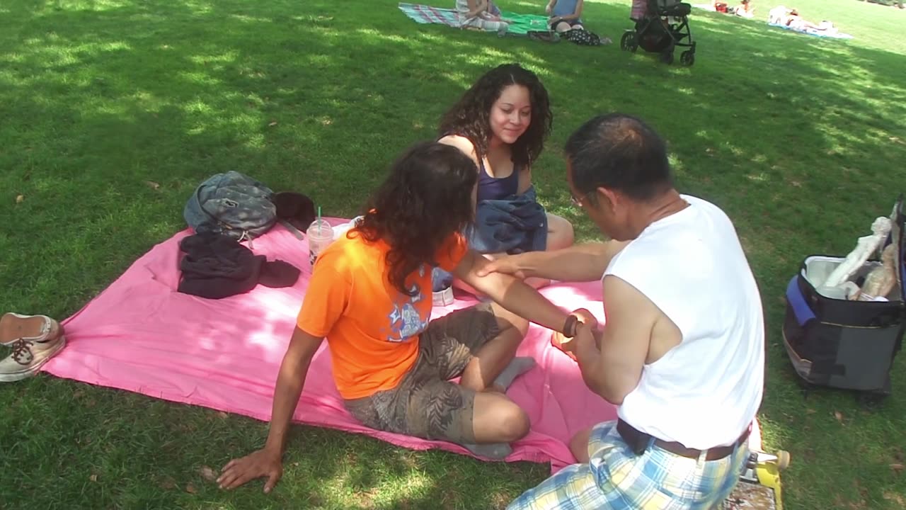 Luodong Massages Man's Knee With Massage Oil At The Park