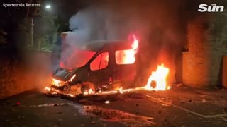 Police van TORCHED outside Dublin asylum hotel as protests turn violent