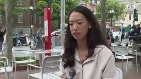 LMAO fight breaks out behind Harvard grad doing an interview. How 2025