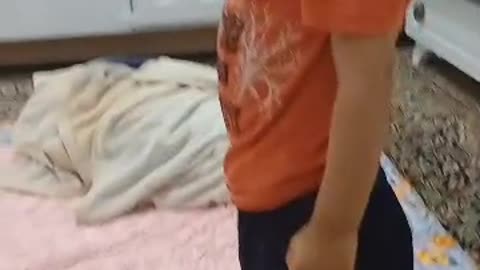 Radmehr, the cute boy, has a small toy rabbit and plays with it.