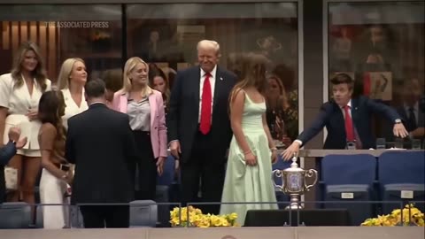 Trump receives a mix of cheers and boos as he attends the US Open