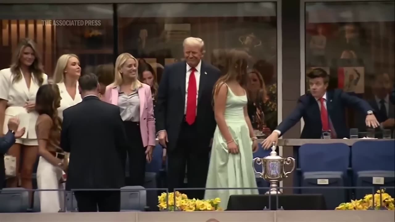 Trump receives a mix of cheers and boos as he attends the US Open