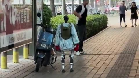 Robot jacks man on moped