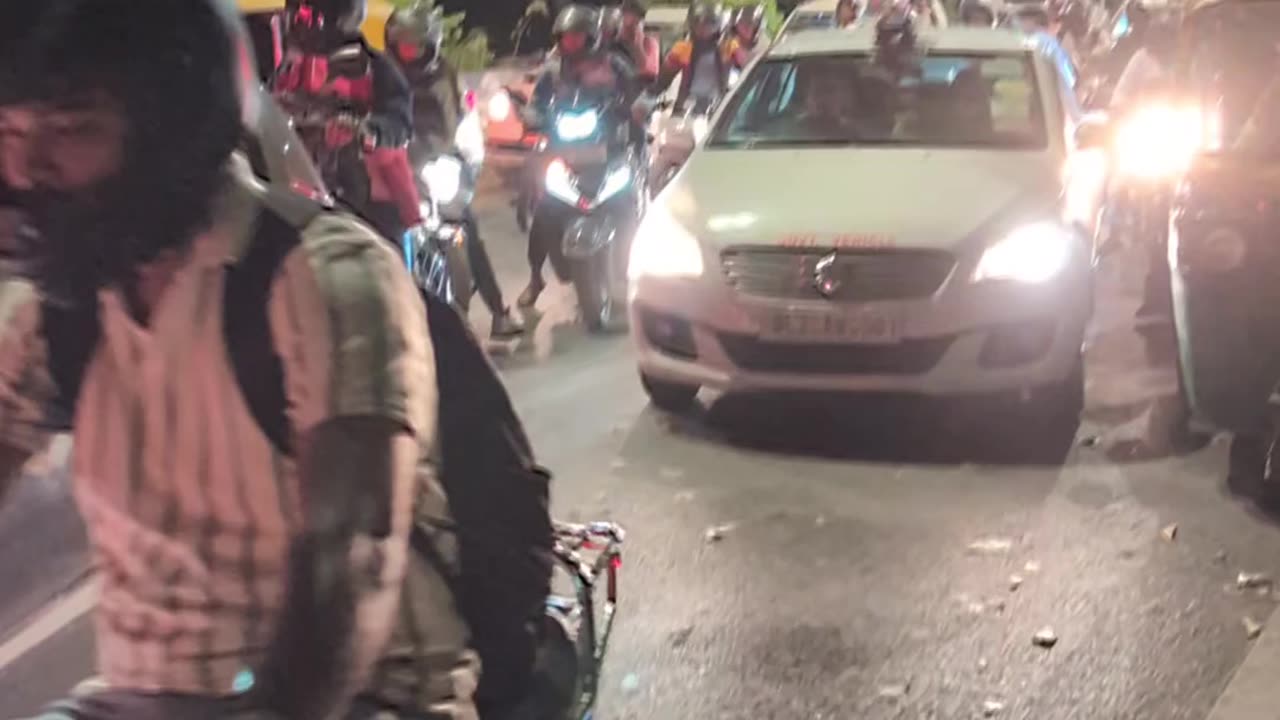 Saturday night beeping at a road crossing in Delhi.