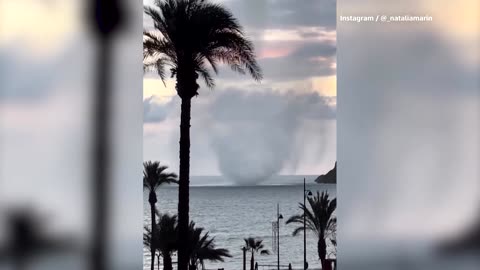 Waterspout hurls debris skyward on Spain's southeastern coast