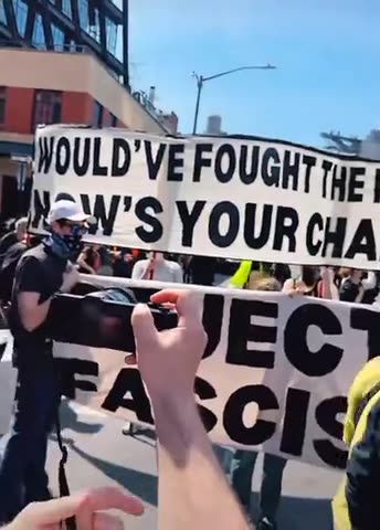 Tesla 'Protesters' Are Inciting Violence With Large Banner Calling to 'Burn a Tesla, Save Democracy'