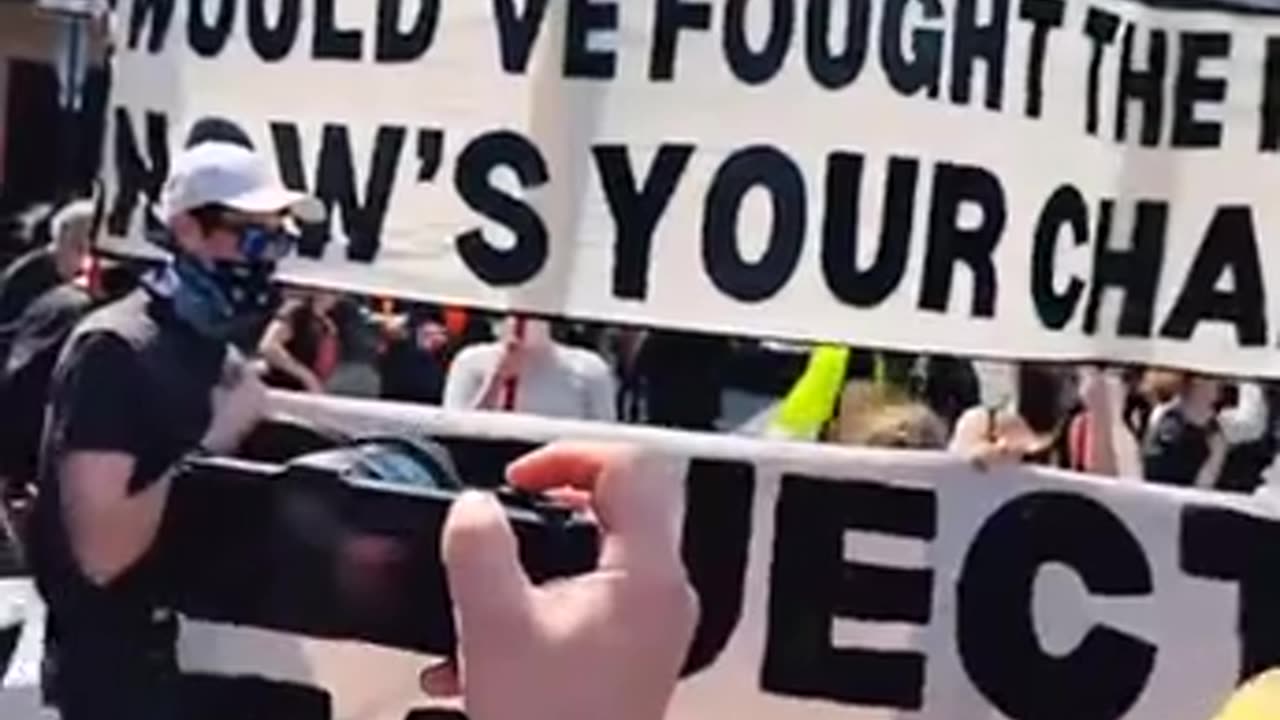 Tesla 'Protesters' Are Inciting Violence With Large Banner Calling to 'Burn a Tesla, Save Democracy'