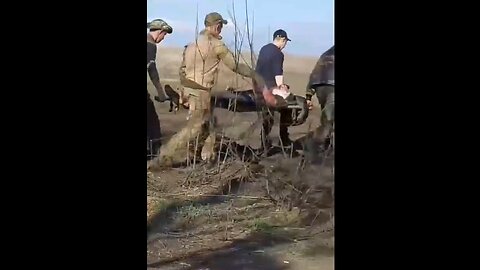 Russian soldiers evacuating wounded troops from the front