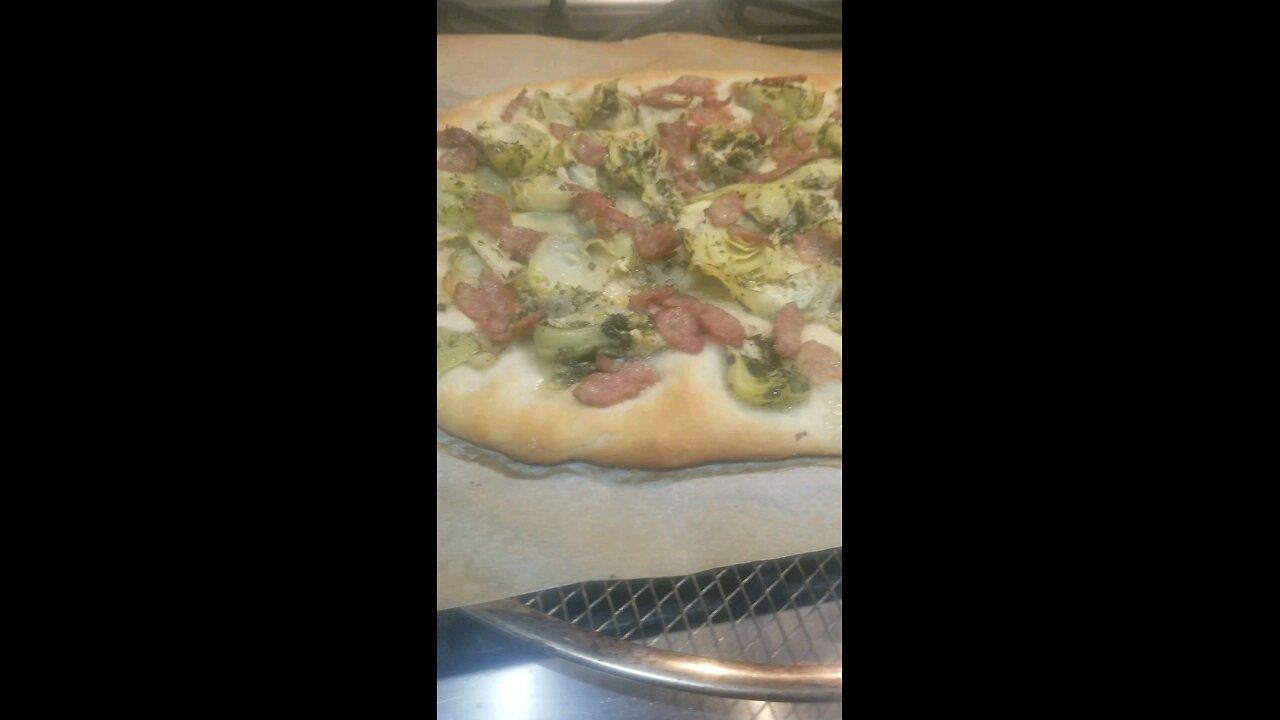Sausage, artichoke, and salad pizza