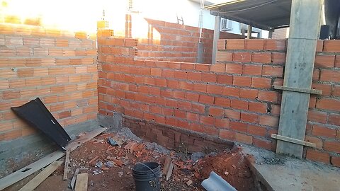 Wall of the area and kitchen combined two windows and a central door
