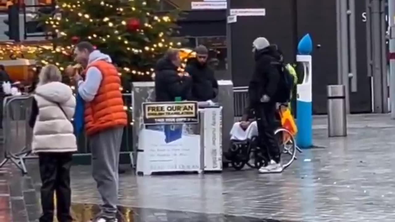Dishing out free Qurans right next to a Christmas tree.