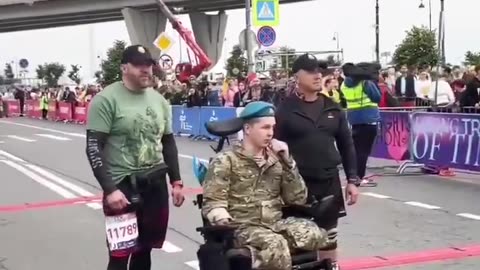 So They Take His Legs Away, and Then Wheel Him into the Street to Give a Speach at a Marathon? Is This Comedy or Irony?