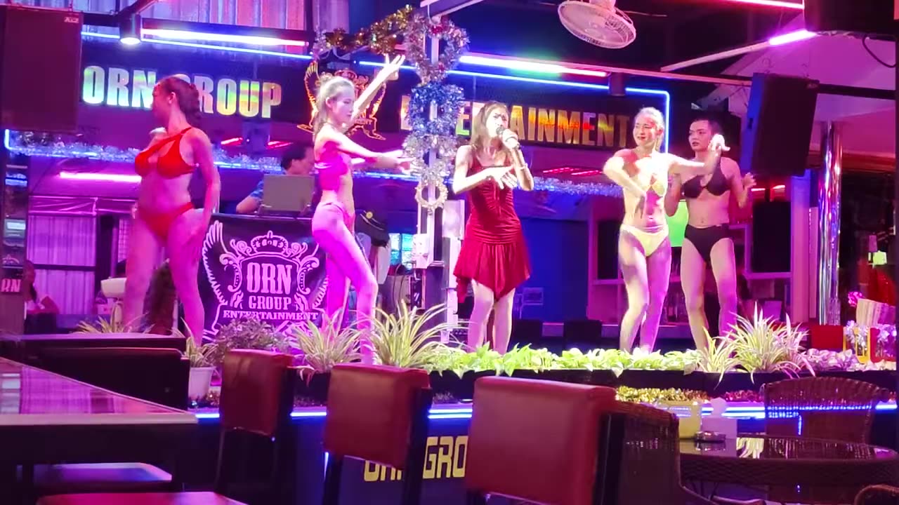 Pattaya. Bikini ladyboys dancing on the stage in a bar
