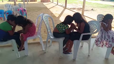 Brazil: FM Marcos and Martinilza teaching the children to pray for one another.