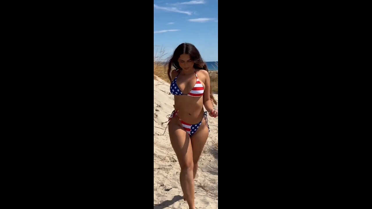 Beautiful curvy brunette in stars and stripes bikini