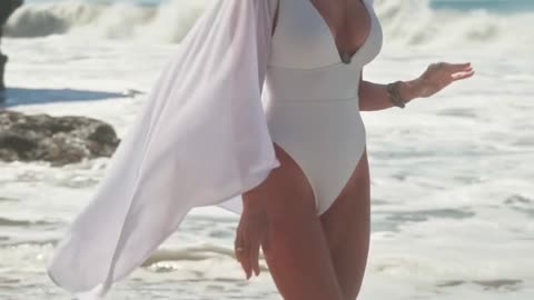 Slim Bikini Model Walking on Beach Wearing Hat – Stunning Summer Vibes