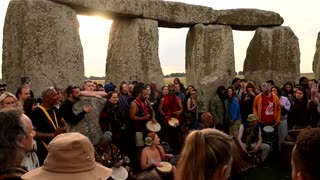 Crowds celebrate the sunrise at Stonehenge for summer solstice