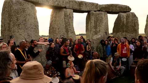 Crowds celebrate the sunrise at Stonehenge for summer solstice
