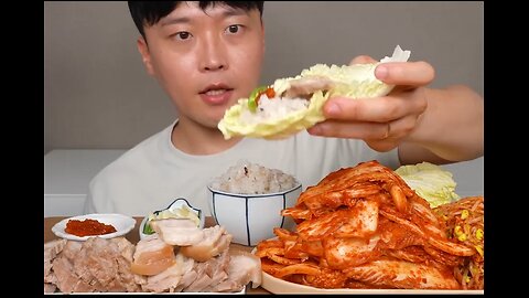 Boiled pork, spicy cabbage kimchi, and other condiments