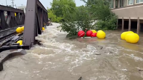 A dangerous flash flood in Wauwatosa, Wisconsin is nearing a railroad bridge,