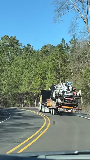 Poorly Loaded Trailer Tips Around Fast Road Curve