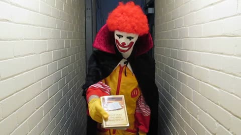 A Jehovah's Witness dressed as a clown presents their Watchtower Truth