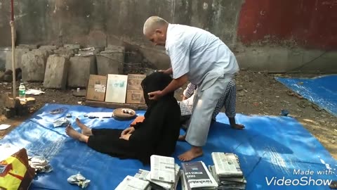Indian street doctor treats with newspapers - street chiropractor / yulichka wants it