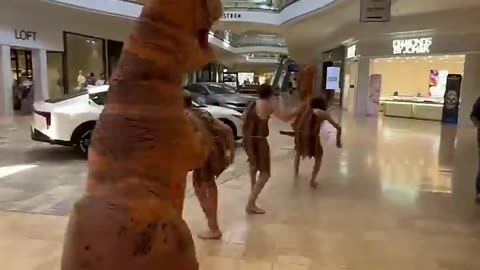 Cavemen with Dinosaur in a Mall