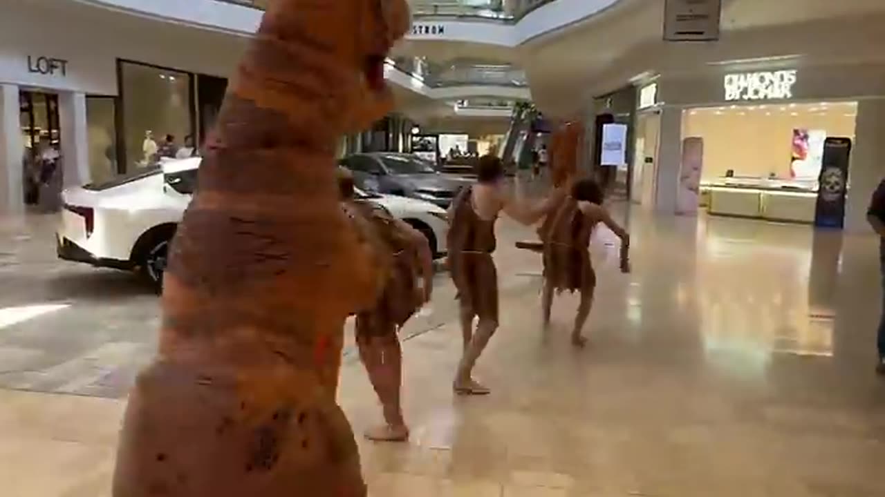 Cavemen with Dinosaur in a Mall