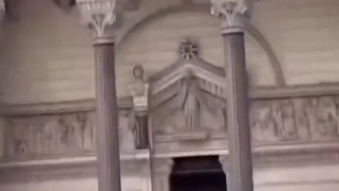 Usual suspect climbs without clothes on sculptures outside Lyon Cathedral, France.
