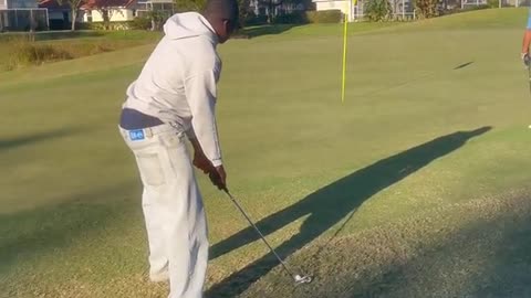 Friend Doubts Five Iron on Green