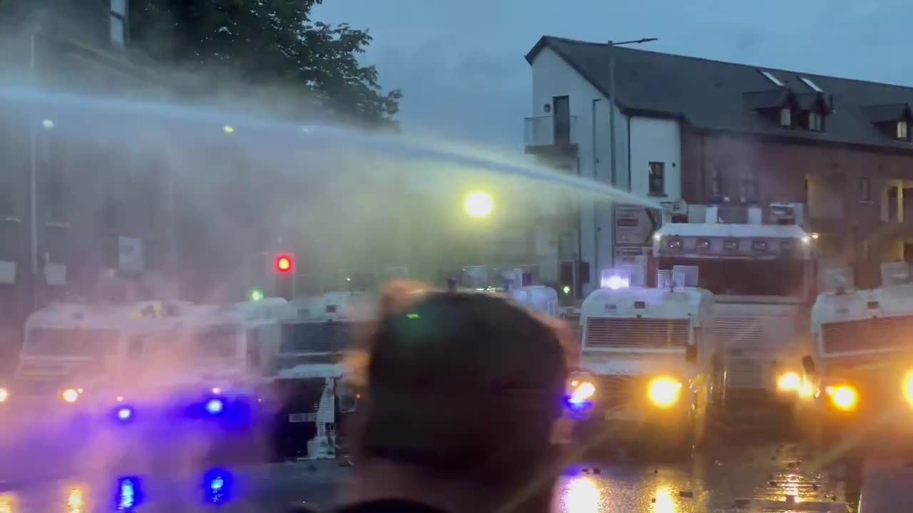 Ballymena Large cheers from crowds as the PSNI use water cannons on them.