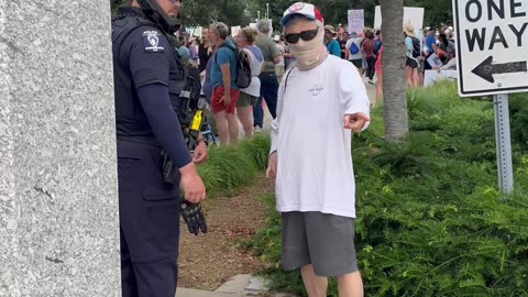 Police instruct protesters not to cover their faces.