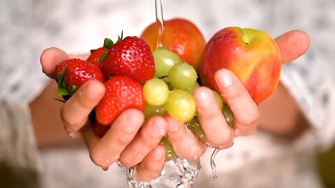 Rinsing strawberries, apples and grapes holding hands